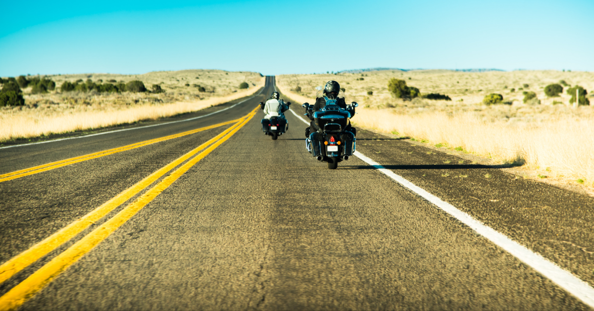 Famous American Historic road to the West - Route 66 with two silhouettes of motor bikers driving their motorcycles (heading North East) South California desert landscape background, U.S.A. Papuchalka