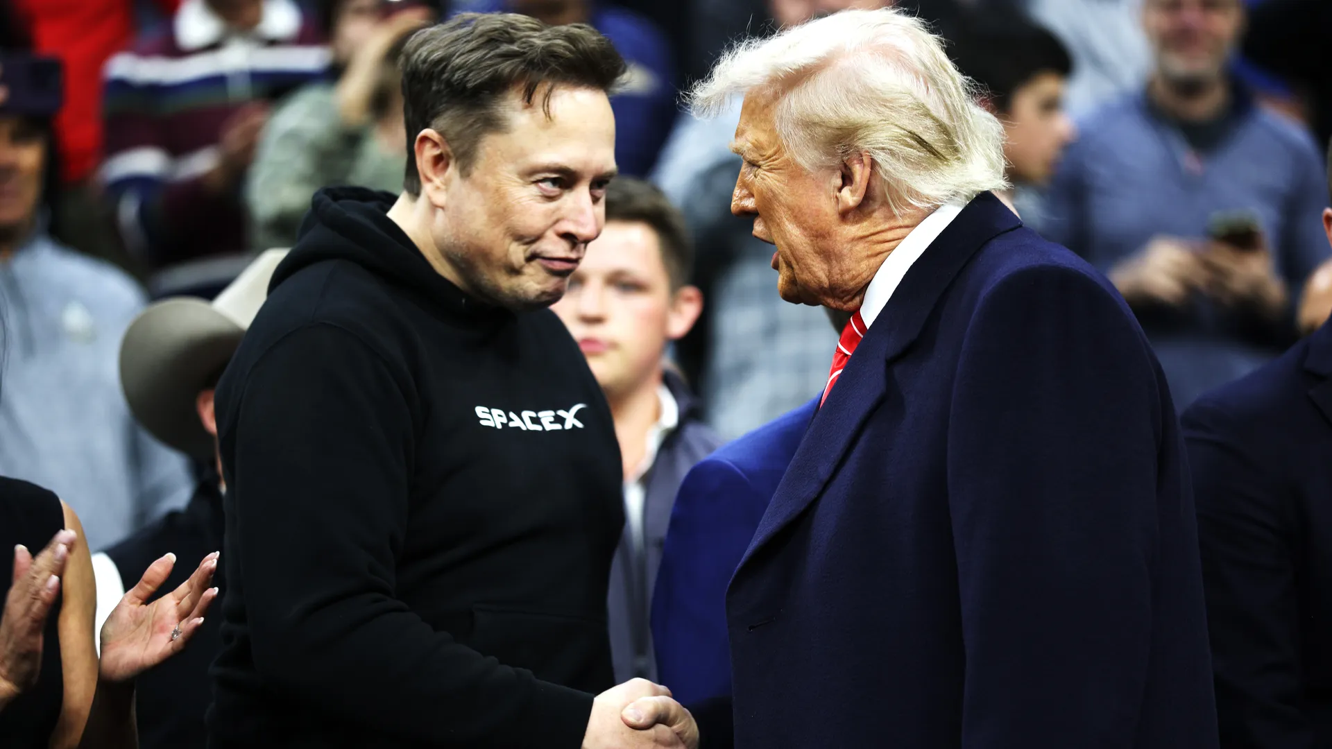Elon Musk, left, shakes hands with President Donald Trump at the finals for the NCAA wrestling championship, Saturday, March 22, 2025, in Philadelphia. Photo: Kayla Bartkowski/Getty Images