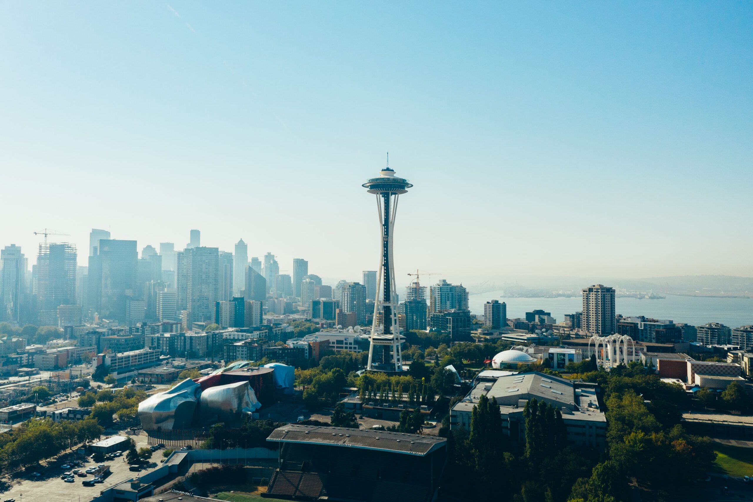 Seattle skyline with Space Needle centered against blue sky, clear day