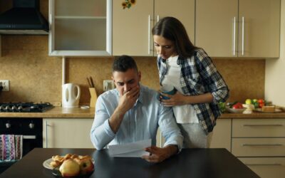 Couple reviewing bills together at their kitchen table